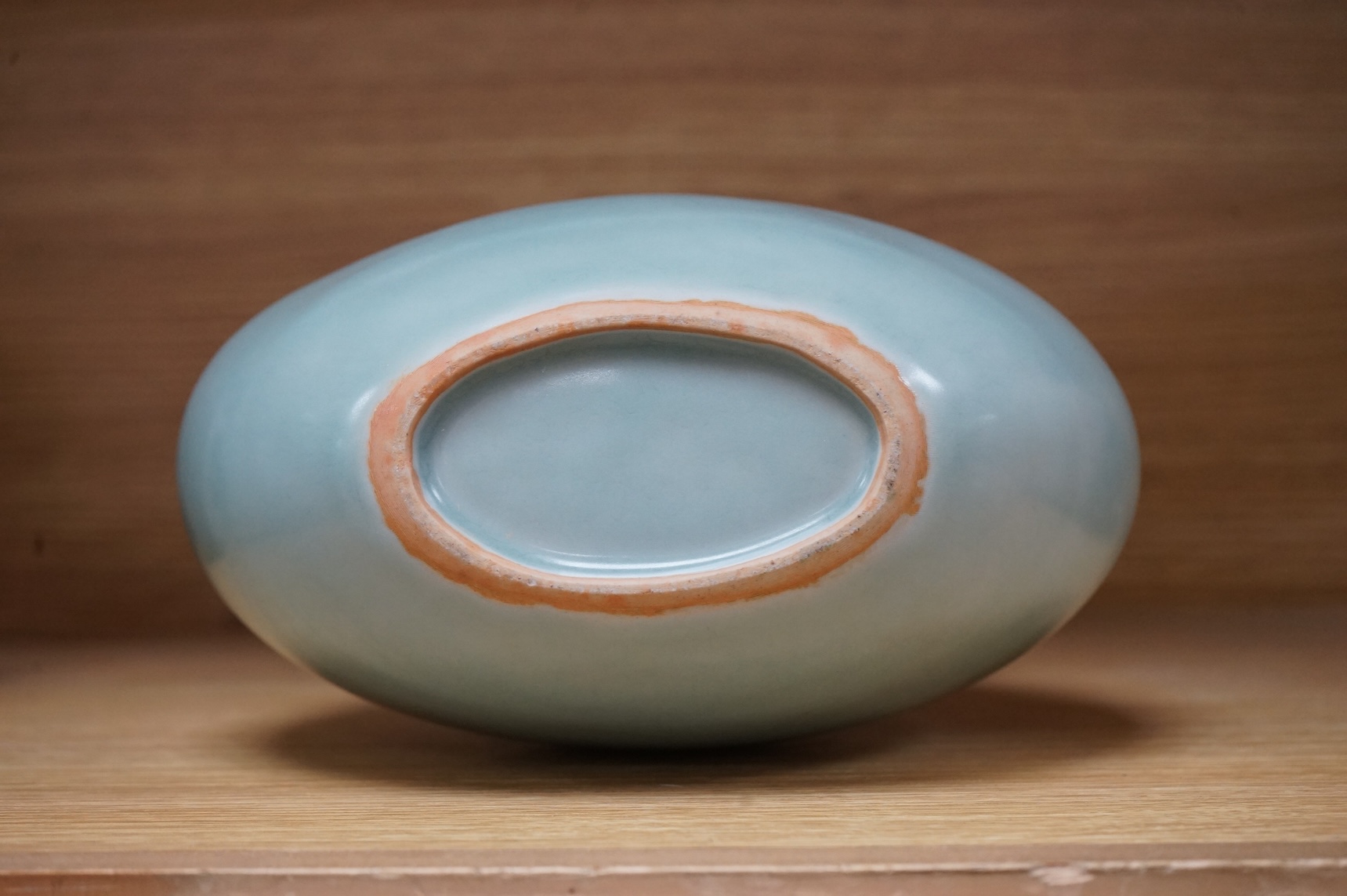 A Chinese celadon glazed two handled moon vase, 24cm high
